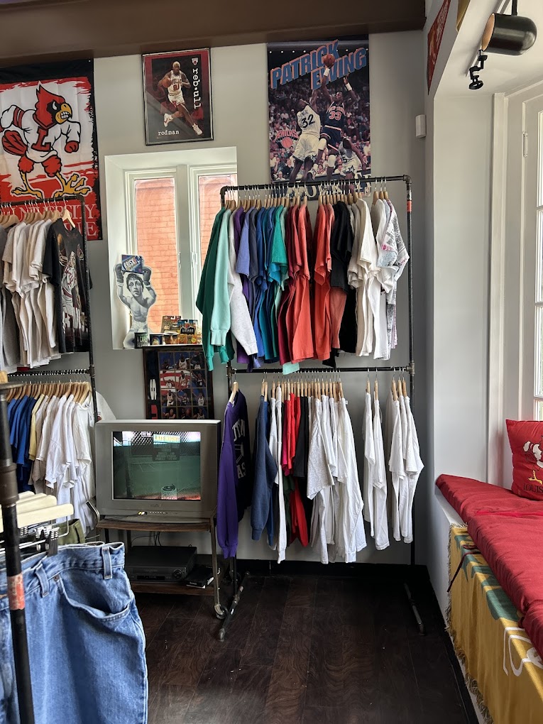 Sports corner, Rodman and Ewing posters, retro CRT TV, Cardinals gear