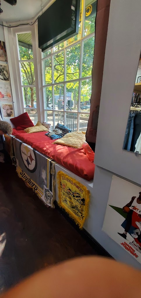 Store interior — window bench and pennants