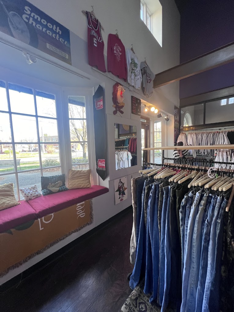Inside 502 Thrifts — warm window bench and vintage racks